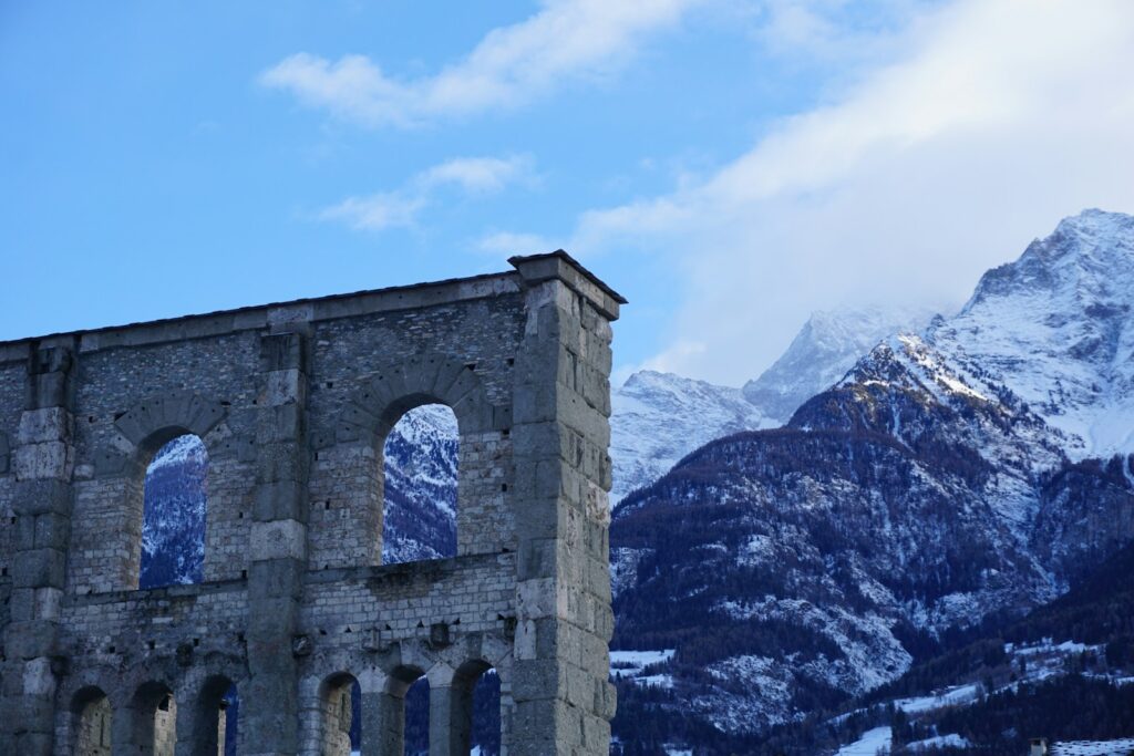 a stone building with a mountain in the background